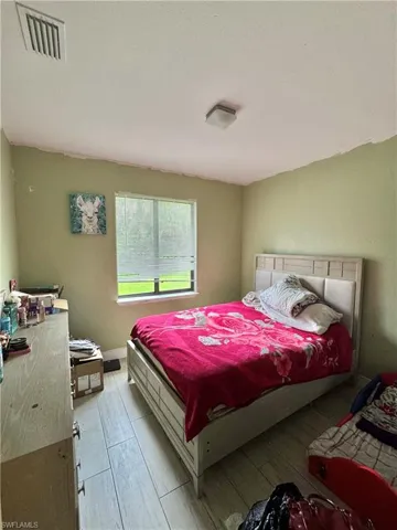 Bedroom with baseboards and light wood-type flooring