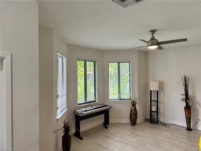 Empty room featuring light wood-style flooring and ceiling fan