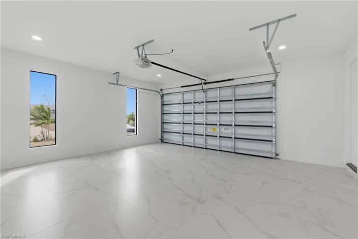 Garage with recessed lighting and a garage door opener
