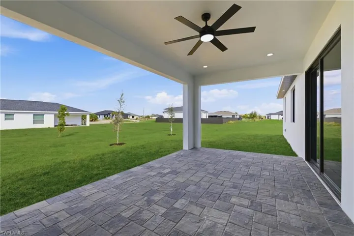 View of patio / terrace with ceiling fan and a residential view