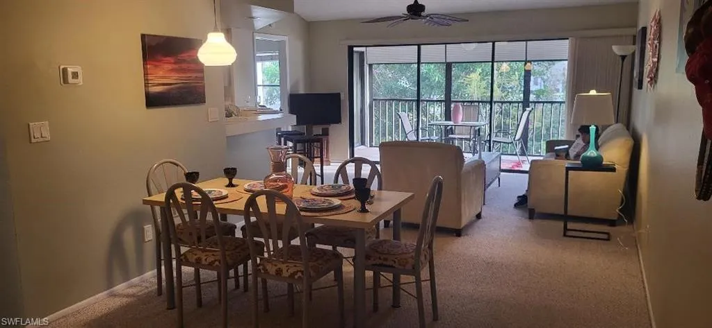 Dining space with carpet floors, baseboards, and a ceiling fan