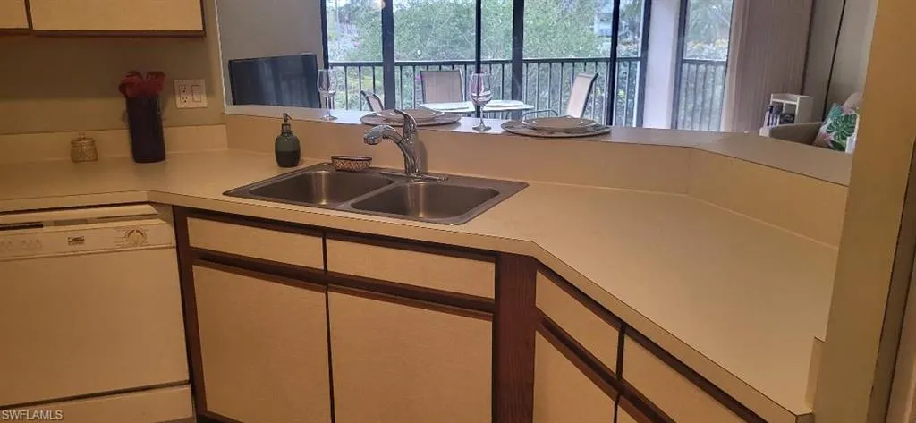Kitchen with white dishwasher, light countertop