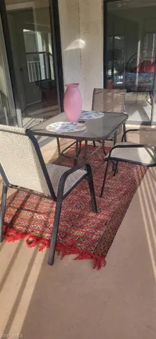 View of enclosed screened patio with hurricane shutters