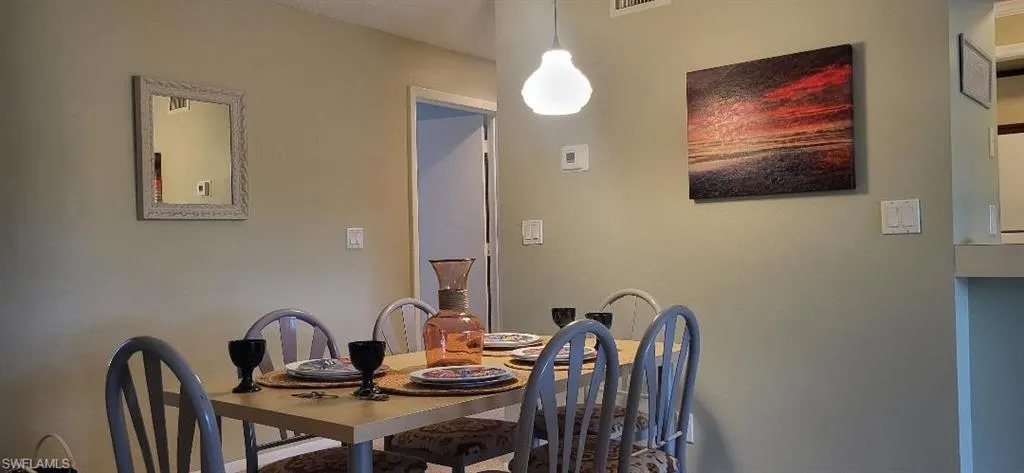 Dining room, walkway to separated 2 other bedrooms and bath so primary is on other side of home