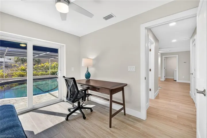 Office area featuring light wood-style flooring and a ceiling fan