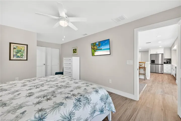 Primary Bedroom with  light wood-type flooring, ceiling fan, and a closet