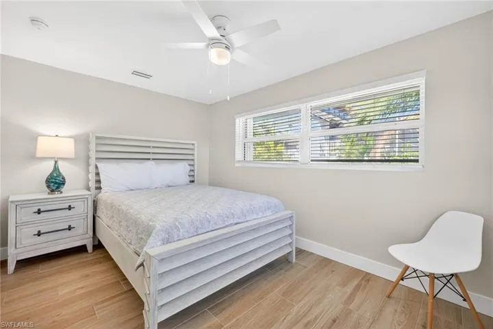 Bedroom featuring wood tiled floors and a ceiling fan
