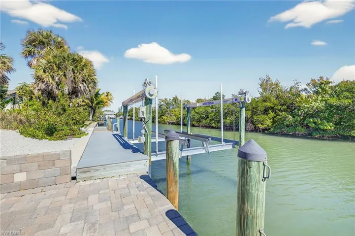 Dock with boat lift and a water view