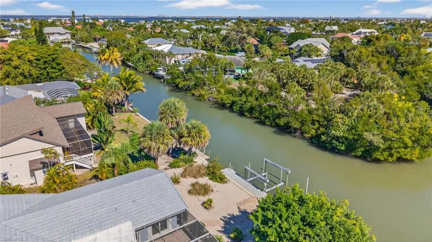 Aerial view of residential area featuring a nearby body of water
