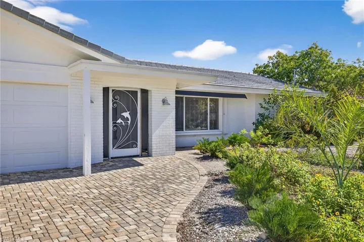 View of exterior entry with brick siding
