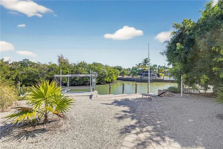 Dock featuring boat lift and a water view