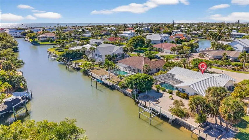 Aerial perspective of suburban area with a nearby body of water