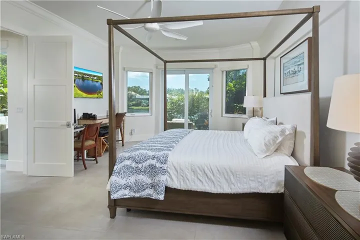 Spacious primary bedroom with en suite bathroom. Doors open onto the lanai.