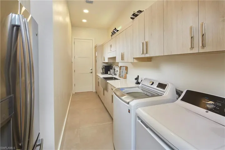 Large laundry room, just off the garage, with so much storage space.
