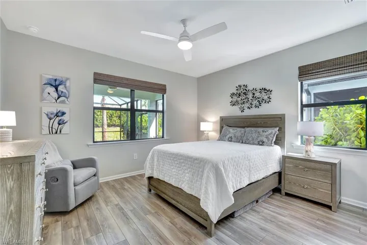 Bedroom with ceiling fan and light wood-type flooring