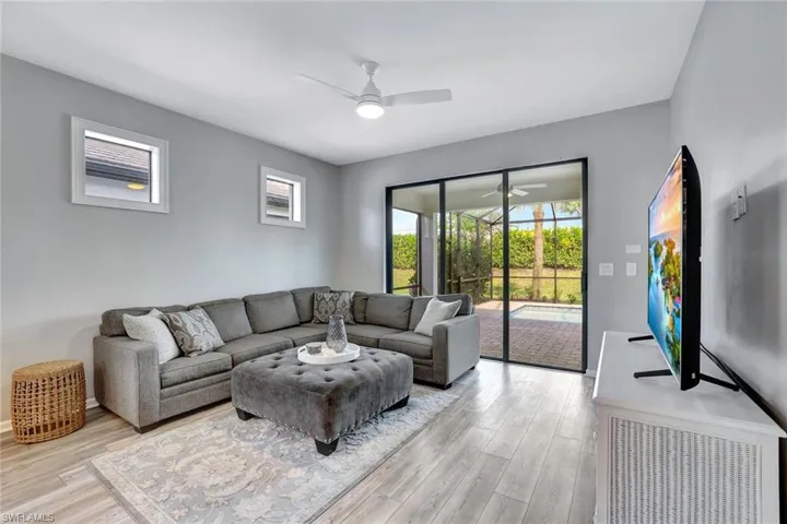 Living room featuring ceiling fan and light hardwood / wood-style flooring