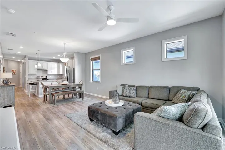 Living room featuring light wood-type flooring and ceiling fan