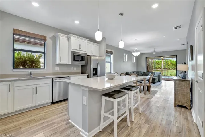 Kitchen featuring white cabinetry, appliances with stainless steel finishes, sink, and light hardwood / wood-style flooring