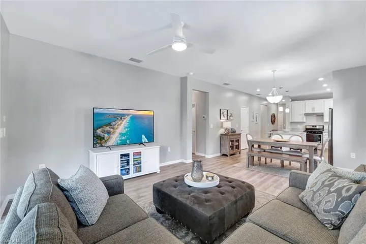 Living room with light wood-type flooring and ceiling fan