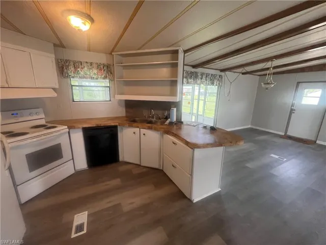 Kitchen featuring white cabinetry, dishwasher, dark hardwood / wood-style flooring, and electric stove