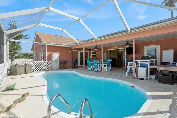 Pool featuring a patio area, outdoor dining space, a lanai, and ceiling fan