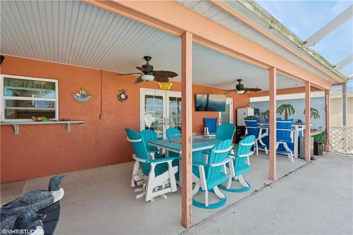 View of patio / terrace with outdoor dining area, ceiling fan, and french doors