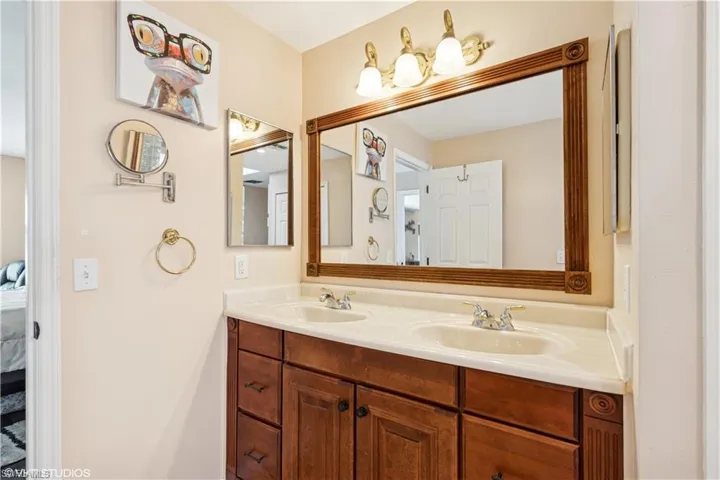 Full bathroom featuring a sink, connected bathroom, and double vanity