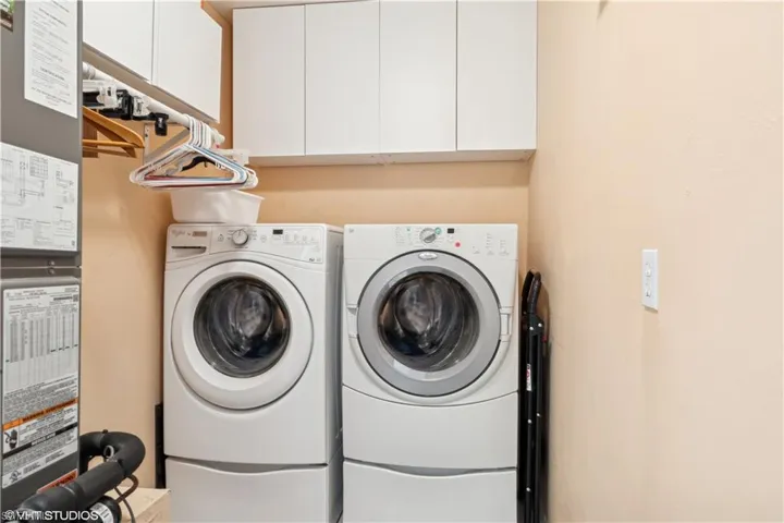 Laundry Room featuring washer and dryer and cabinet space