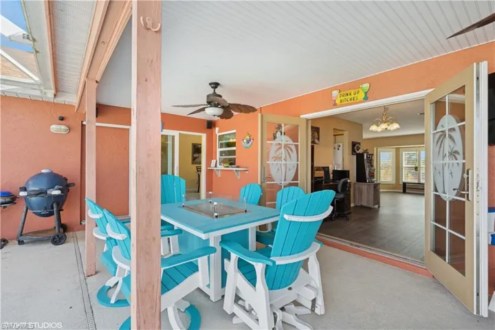 View of patio featuring a grill and ceiling fan