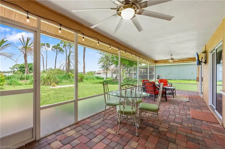 Sunroom featuring a ceiling fan