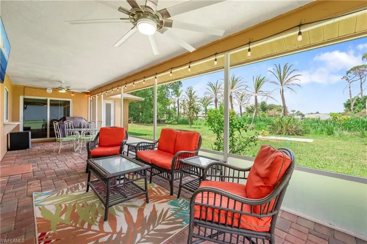 Sunroom featuring a ceiling fan and an outdoor living space