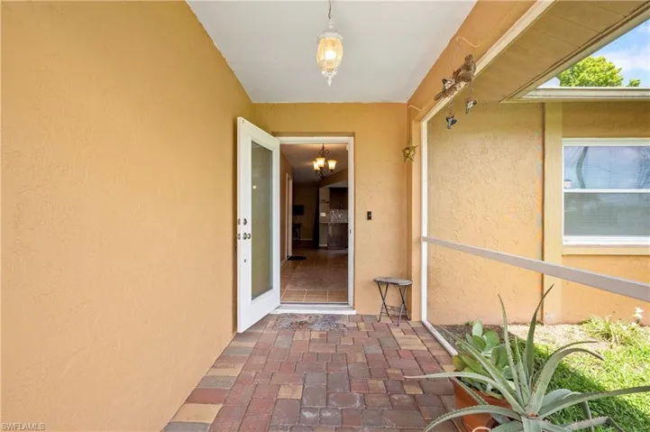 Doorway to property with stucco siding