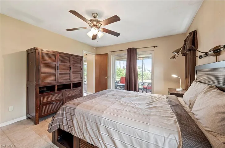 Bedroom featuring access to outside, baseboards, light tile patterned flooring, and a ceiling fan