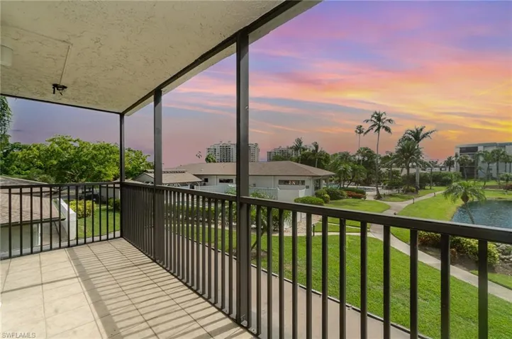 Balcony at dusk, overlooks pond and lush, tropical grounds