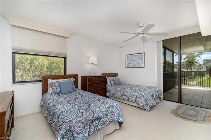 Guest bedroom enjoys sliders to balcony