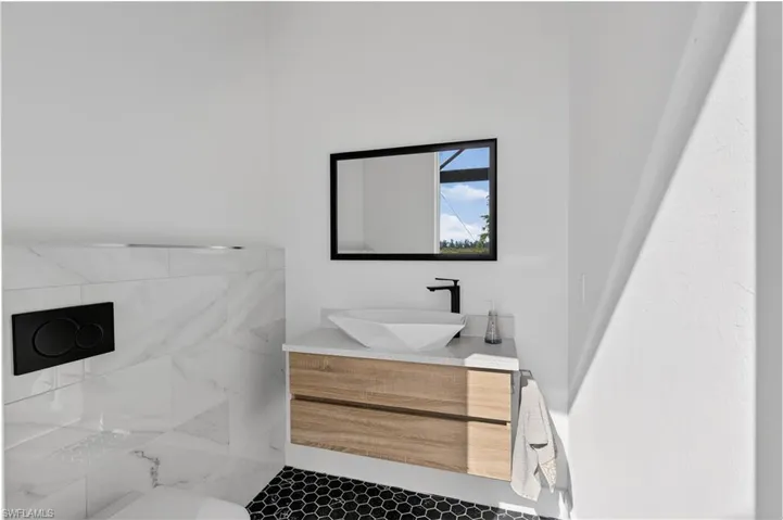 Pool bathroom featuring vanity and tile patterned floors