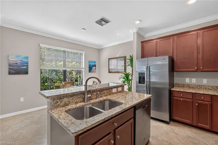 Kitchen featuring all granite countertops and stainless steel appliances.