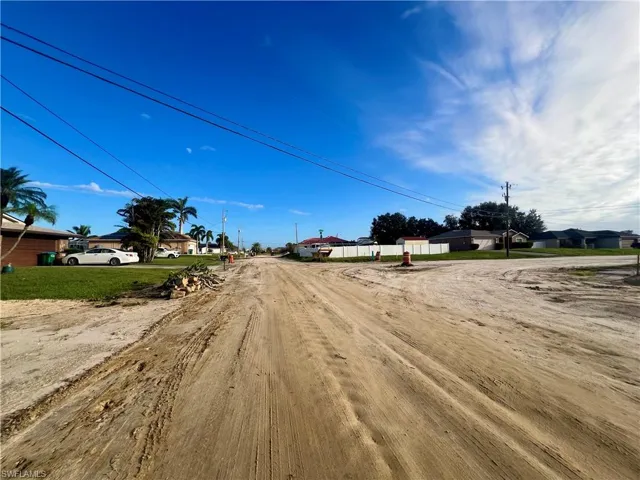 View of dirt / gravel road with a residential view