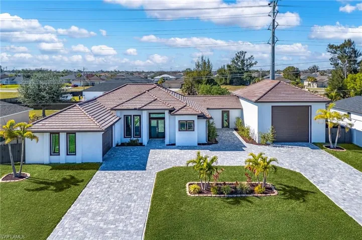 View of front of house featuring a garage and a front yard