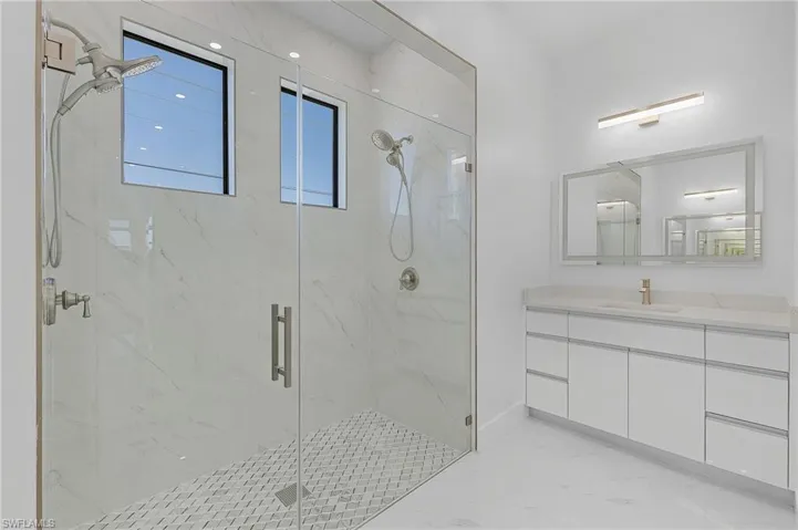 Bathroom featuring vanity and an enclosed shower