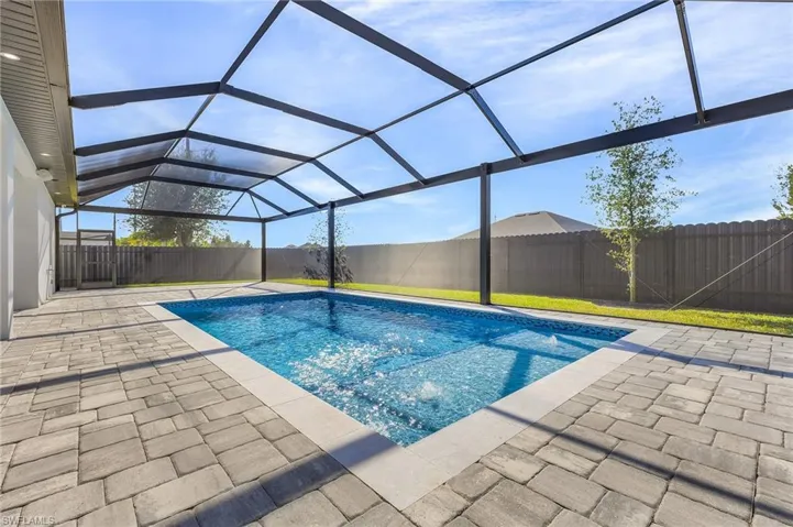 View of swimming pool featuring a lanai and a patio