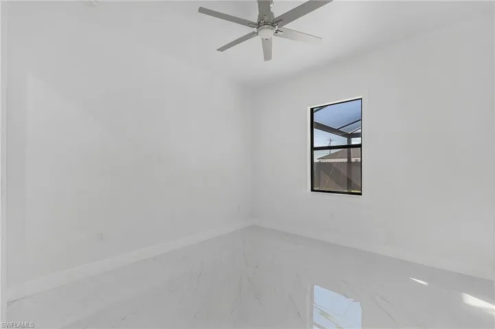 Spare room with ceiling fan