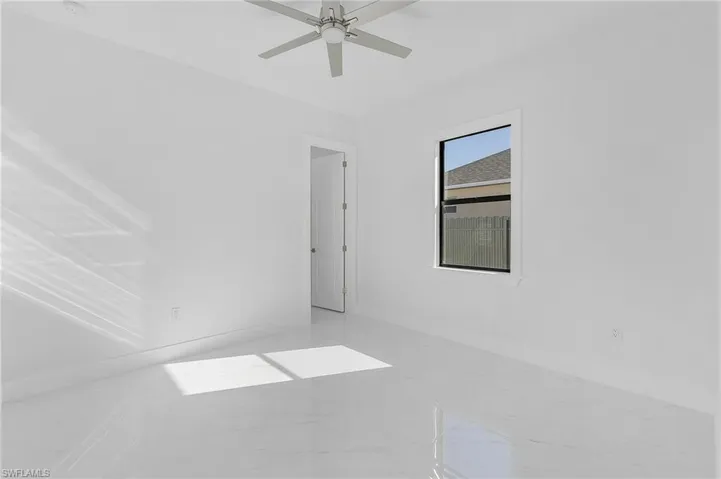 Unfurnished room featuring ceiling fan