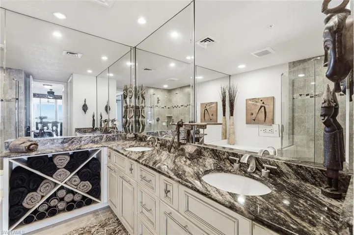 The redesigned primary ensuite bath has been thoughtfully reimagined as a luxurious private retreat, featuring custom cabinetry with exceptional storage, a relaxing soaking tub, and a separate walk-in shower. Every detail has been carefully curated to create a spa-inspired atmosphere of comfort, elegance, and sophistication.