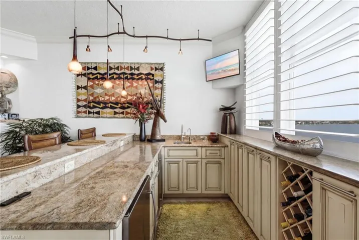 Your custom waterfront bar is designed for effortless entertaining, featuring a built-in wine rack, elegant granite countertops, a dedicated refrigerator, and an icemaker—creating the perfect gathering space to enjoy cocktails, fine wine, and breathtaking waterfront views.