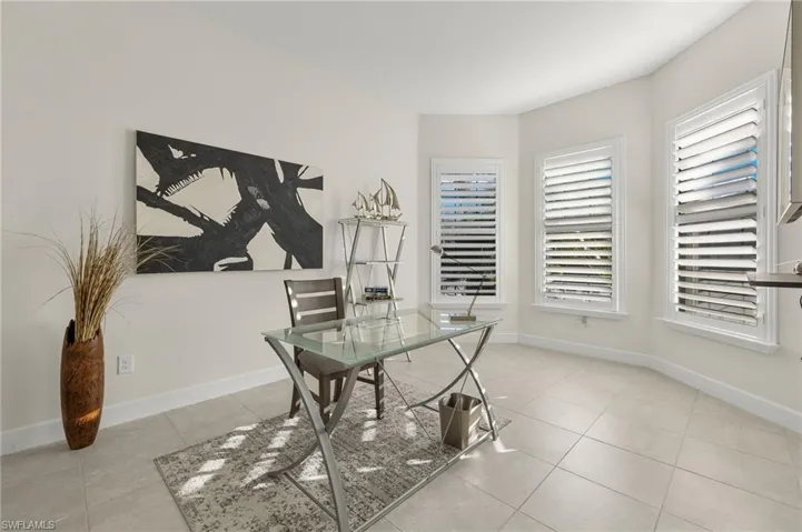 Office area featuring light tile patterned floors