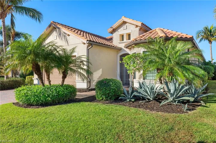 Mediterranean / spanish home with a front yard