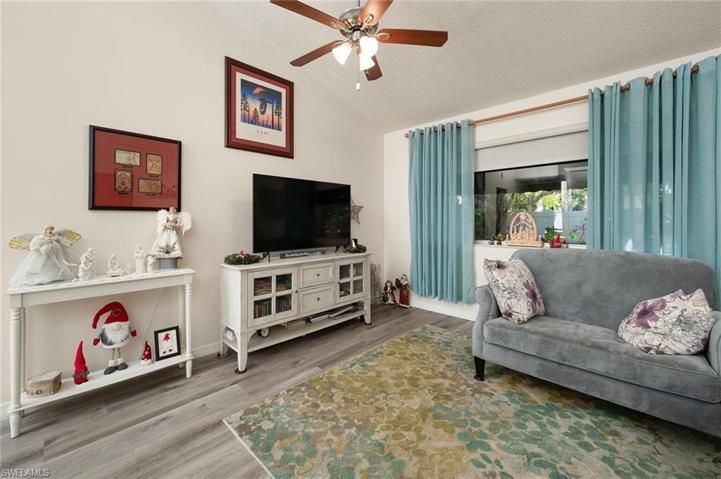 LIVING ROOM OPEN TO THE KITCHEN AREA. SITUATED IN THE BACK OF THE HOME OVERLOOKING THE PEACEFUL BACK YARD PARADISE