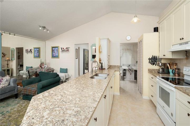 KITCHEN W/GREAT CABINET AND GRANITE COUNTERTOPS SPACE OVERLOOKS LIVING ROOM