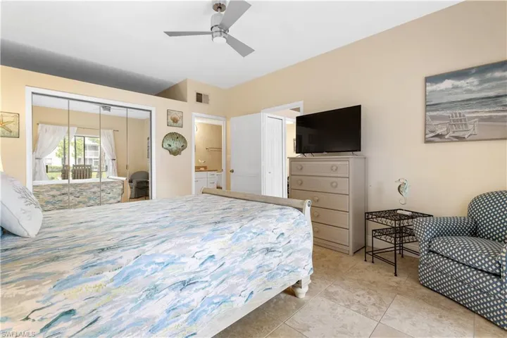 Large Primary with a huge walk in closet behind the mirrored doors